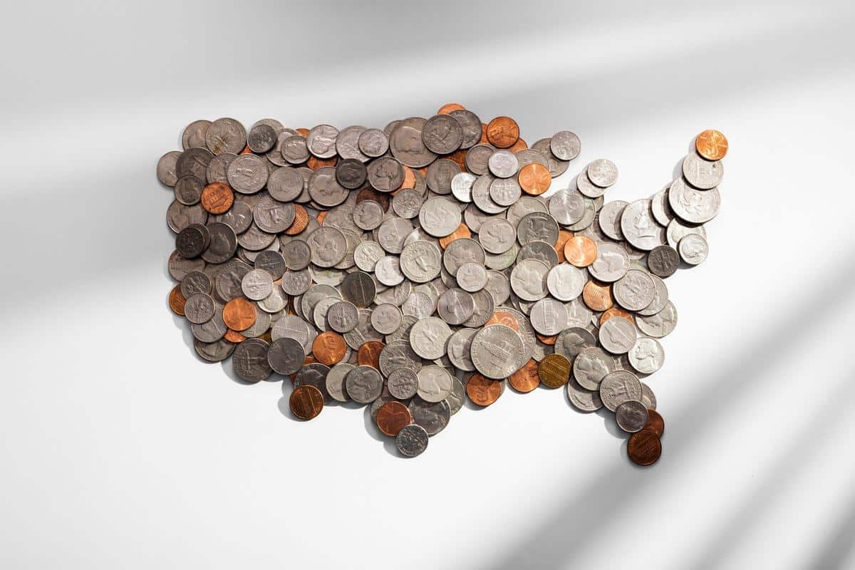 Coins arranged in the shape of the United States map symbolizing economic and monetary information.